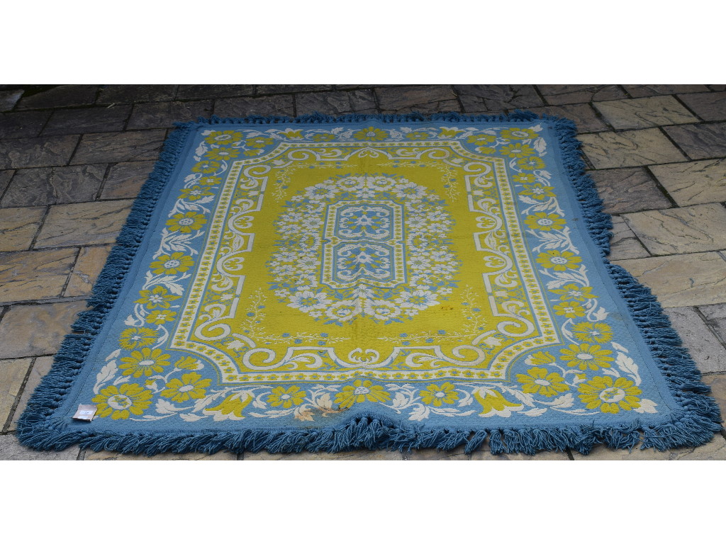 A Belgian quilted rug, decorated floral