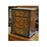 A walnut miniature chest, of four gradua