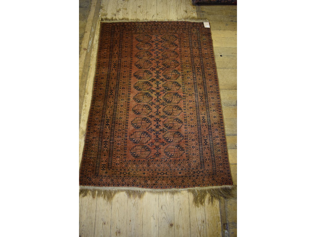 An Afghan rug, decorated central lozenge
