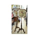 A pair of Victorian rosewood pole screen