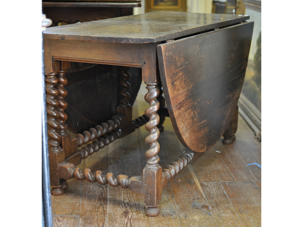 A 17th century walnut gateleg table, on