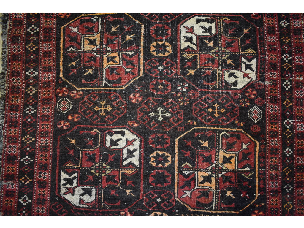 An Afghan rug, decorated motifs on a bla - Image 4 of 4