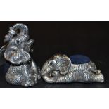 A silver coloured metal novelty pincushi