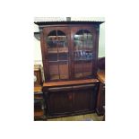 A Victorian mahogany bookcase on cupboar