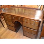 A 19th century oak kneehole desk, with p