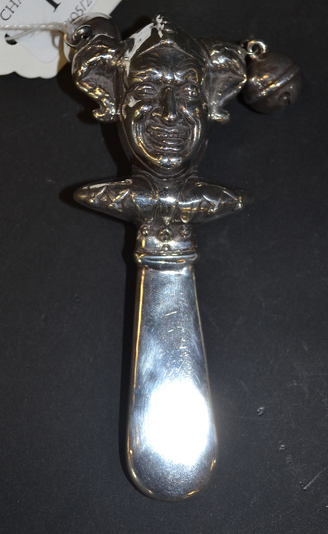 A silver baby's rattle, in the form of a