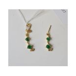 A pair of yellow coloured metal, emerald