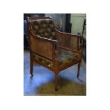 An early 19th century mahogany bergere a