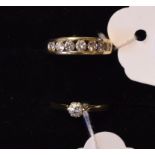 A 9ct and seven stone diamond ring, a 9ct gold solitaire diamond ring,