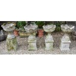 A set of three reconstituted stone garden urns on stands, 48 cm wide,