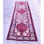A Persian Sarab runner, with geometric motifs on a cream ground within a multi border,