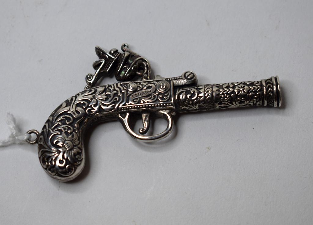 A silver novelty whistle,