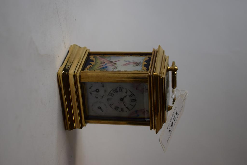 A miniature carriage clock, decorated ceramic panels,