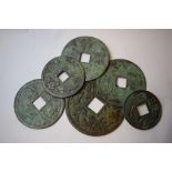 A Chinese bronze disc, decorated dragons and with a square centre, 13.