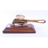 A mahogany and brass tabletop sugar cutter