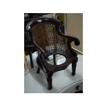 A 19th century child's bergere style commode chair