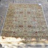 An Eastern rug, decorated floral motifs on a turquoise ground, within a multi border, 228 x 158 cm,