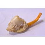 A Meerschaum type pipe, the bowl carved a gentleman, other pipes,