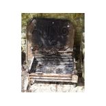 A steel fire grate, 65 cm wide, and an iron fire back, inscribed ANNO 1676 and Fleur de Lys,