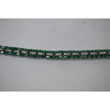 A silver and emerald double line bracelet