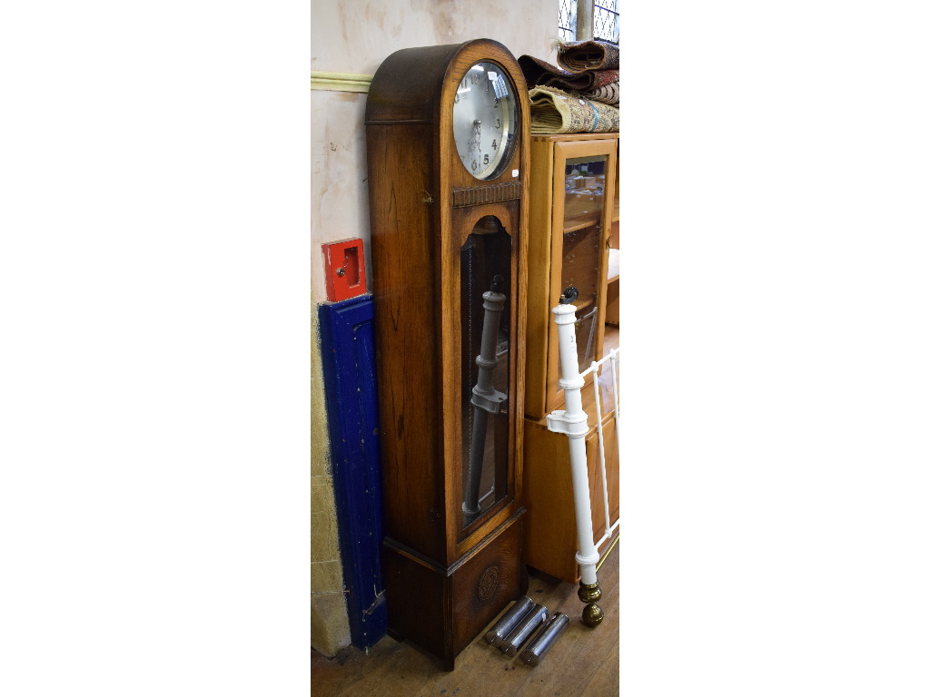 A 1930s longcase clock, the 25 cm diameter silver dial with Arabic numerals,