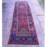 A Persian Brojerd runner, with geometric motifs on a blue ground within a multi border,