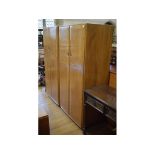 A pair of Ercol elm wardrobes,