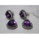 A pair of silver and amethyst drop earrings