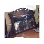 A fret carved mahogany overmantel mirror, surmounted an eagle,