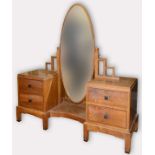 An Gordon Russell style dressing chest with an oval mirror, stepped design and on block legs,