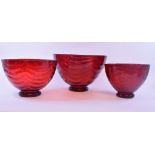A Whitefriars set of three graduated ruby glass bowls, the largest 27 cm wide,