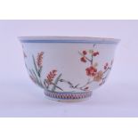 A late 19th century Japanese tea bowl, decorated flowers and foliage,