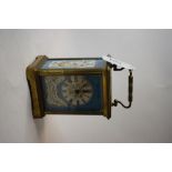 A brass carriage clock, later decorated blue porcelain panels,