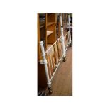 A white painted and brass double bed frame,