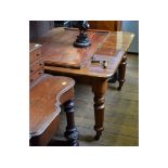 A Victorian mahogany extending dining table, on turned legs, with an extra leaf and winding handle,