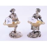 A pair of figural table salts,