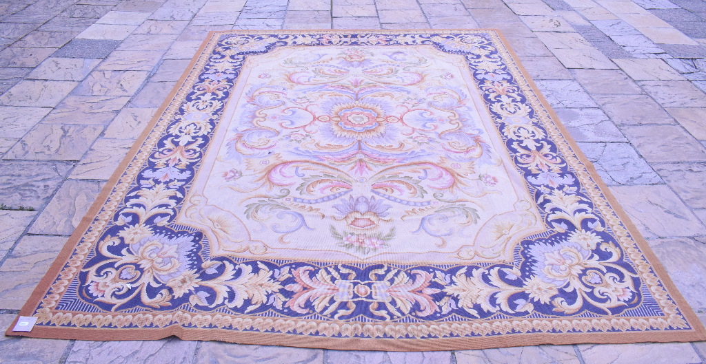 A large Aubusson style needlework rug, decorated foliage,