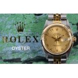 A gentleman's Rolex Oyster Perpetual Datejust wristwatch, the champagne dial with Arabic numerals,