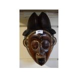 An African style carved wood and painted mask, 23 cm wide,