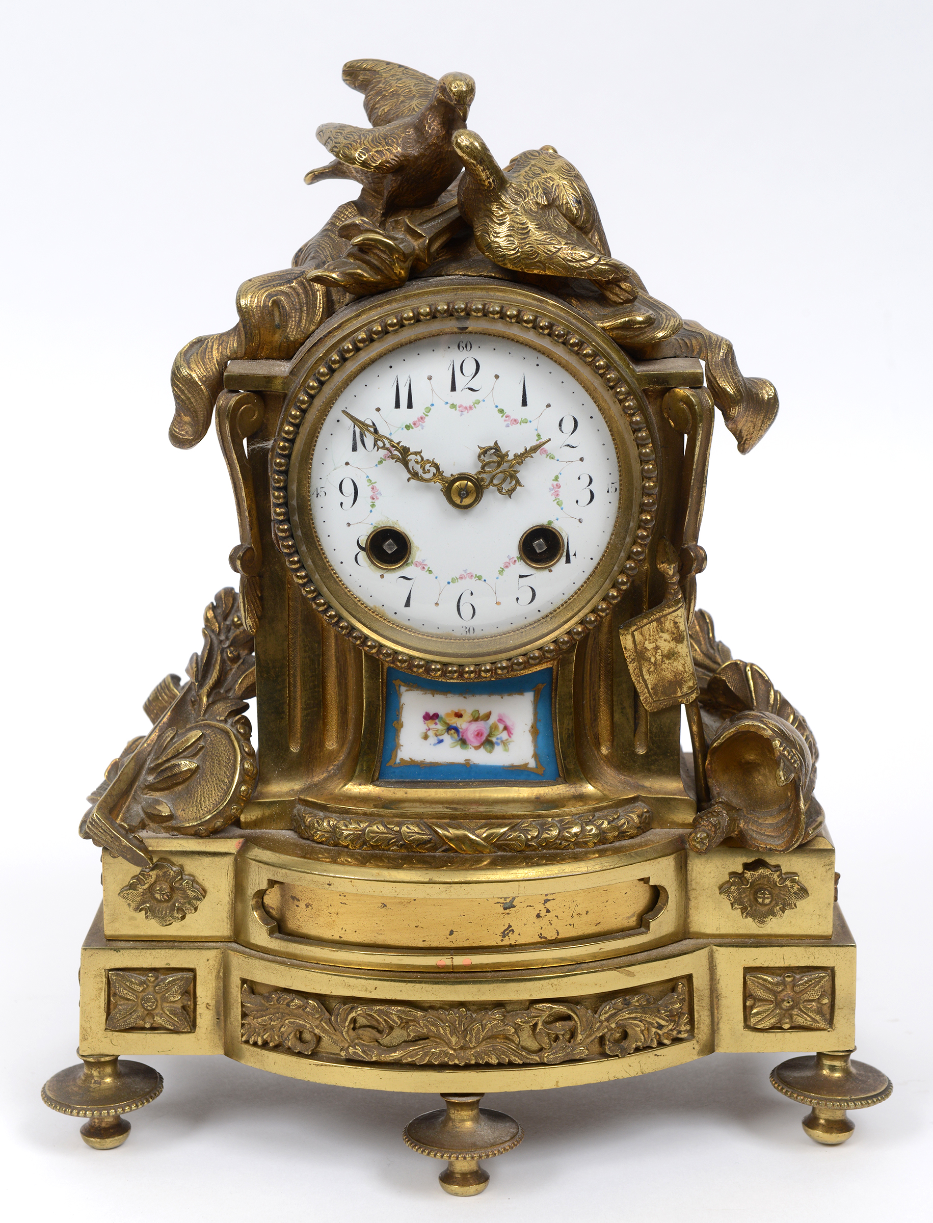 A French mantel clock, the white enamel dial with Arabic numerals and painted roses,