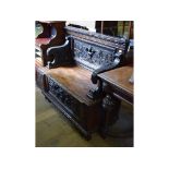 A carved oak settle, 108 cm wide,