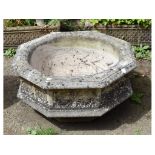 A large reconstituted stone planter,