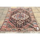 A Persian rug, central medallion on a black ground, within a multi border,