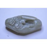 A jade pebble, carved a scholar in a landscape,
