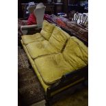 A Bergere three seater sofa, with black chinoiserie style decoration, having double caned sides,
