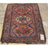 A Shiraz rug, with stylised motifs on an orange/red ground,