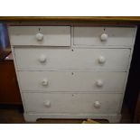 A white painted pine chest, of two short and three long drawers, 100 cm wide, and a pine cupboard,