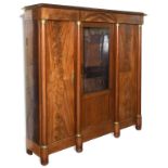 A 19th century Empire style mahogany bookcase, with brass mounts,