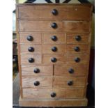 A pine table top chest of drawers, 32 cm wide, and a dolls house,