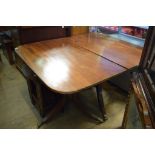 A Regency style mahogany twin pillar dining table, inset and extra leaf, 180 cm wide,